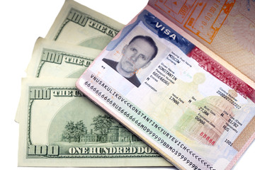 The American visa on page of the Russian international passport and US dollars..