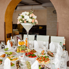 Banquet wedding table with dishware.