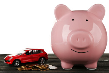 Piggy bank style money box on wooden table, isolated on white