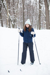 Portrait of young woman with ski in winter time