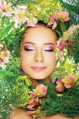 beautiful young girl with flowers near face