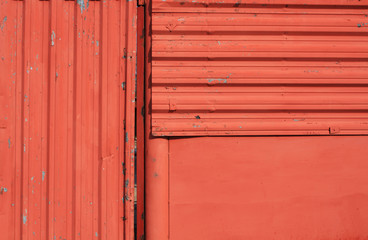 Red grungy metal wall texture.