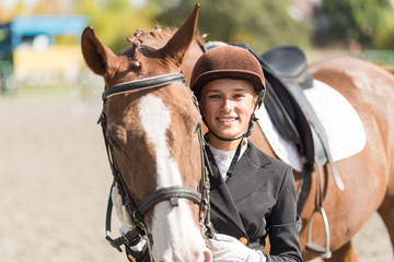 Young rider girl with her horse