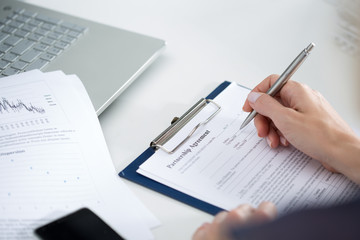 Business woman filling partnership agreement