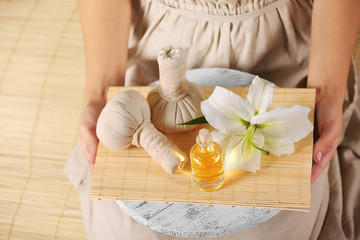 Obraz na płótnie Canvas Female hands with tray of spa products, at spa salon