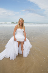 Fototapeta na wymiar Blond bride woman at the beach at summer time