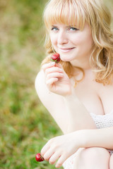 Woman with strawberries outdoor 