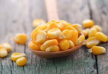 corn in the spoon on wooden