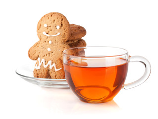 Glass cup of black tea with homemade cookies and gingerbread man