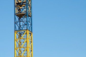 yellow crane ladder and blue sky on building site
