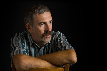 Portrait of mature Ukrainian peasant in low key