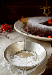 Homemade chocolate Christmas cake sprinkled with sugar powder