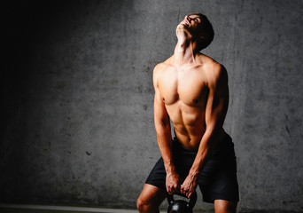 Quiters don't win! Photo of a weightlifter doing some repetitions with a kettlebell