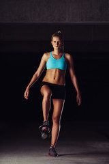 Fototapeta na wymiar Fit bodybuilder exercising her legs