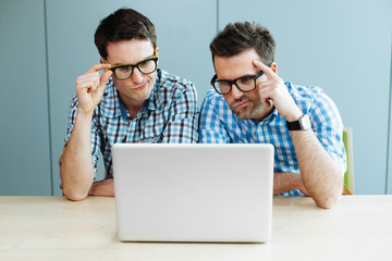 Two computer geeks in office