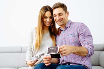 Pregnant couple browsing their future baby scans