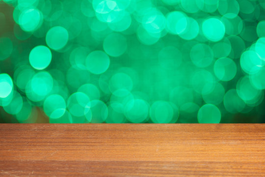 Fototapeta Empty wooden plank. Empty table with bokeh background. Product display montage. Vintage bokeh background. Gold retro bokeh. Fairy defocused backdrop. Celebration wallpaper.  