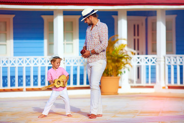 happy family playing music and dancing on caribbean street