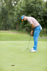 Fototapeta premium Young man playing golf