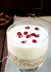 Healhty breakfast with oatmeal, greek yogurt and pomegranate