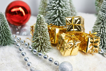 Gifts in gold packaging near Christmas trees