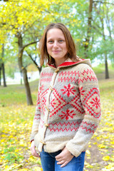 Hipster woman happy smiling relaxing in the autumn park.