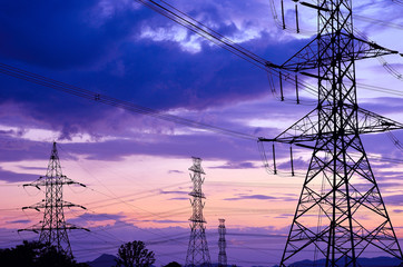 High voltage electricity pylon against blue sky