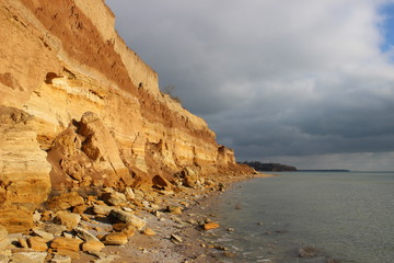 Rock near the sea on the background of a stormy sky