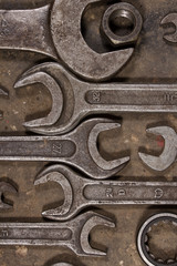 Set of wrenches on oiled floor of the garage and nut