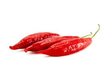 Three red peppers on white background