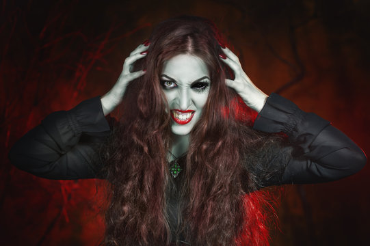 Screaming halloween beautiful vampire with long hair