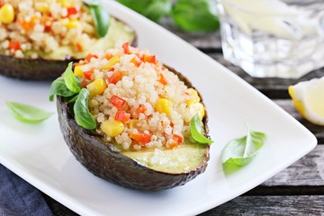 Grilled avocado staffed with quinoa vegetables salad.Selective focus 