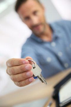 Real estate agent giving keys to property owner