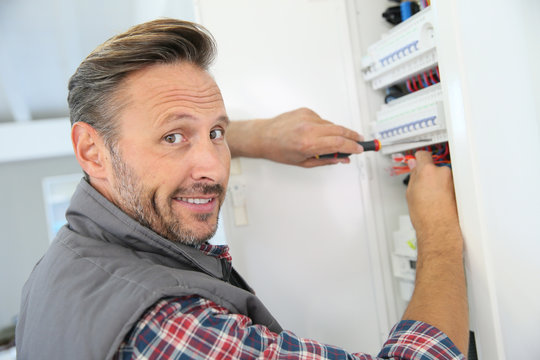 Electrician fixing electric panel in private home