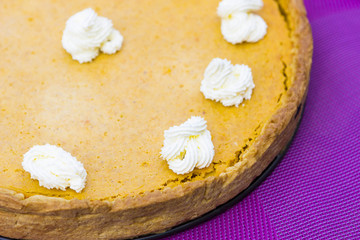 Fototapeta na wymiar Sweet pumpkin pie with cream close up