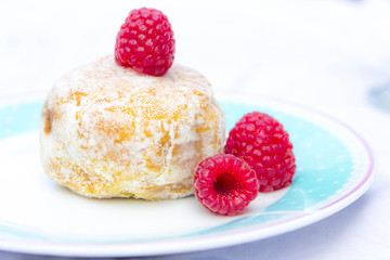 Glazed doughnut with raspberry close up