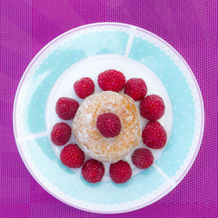Glazed doughnut with raspberry close up