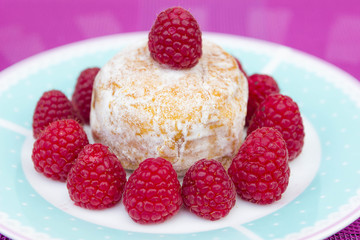 Glazed doughnut with raspberry close up