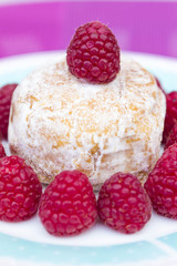 Glazed doughnut with raspberry close up