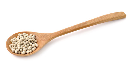 Wooden spoon and peppercorn on white background