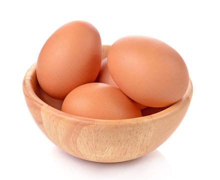 egg  in a wooden bowl isolated on white background