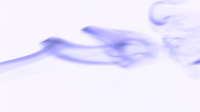 Silky colored smoke flowing in the air on a white background.