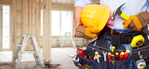 Builder handyman with construction tools.