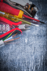 Electrician&acirc;s set on scratched metallic background electricity