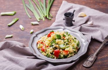 Tabbouleh, an Arabian vegetarian salad made of couscous, tomato, cucumber, onion, garlic, parsley...