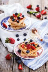Waffles with strawberries and blueberries with honey,  for Breakfast,Belgian.selective focus