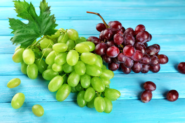 White and red grape on blue wooden background