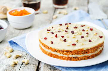 raw vegan carrot cake with cashew cream and dried cranberries