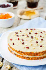 raw vegan carrot cake with cashew cream and dried cranberries