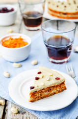 raw vegan carrot cake with cashew cream and dried cranberries
